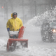 A worker uses a snowblower on Clarendon St. as Winter Storm Skylar bears down on March 13, 2018 in Boston, Massachusetts.